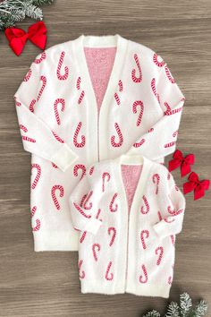 *Each cardigan sold separately* Mom & child cardigans both feature a white design with candy canes Long sleeve design makes it a perfect pick all season Ultra soft material for comfort & ease These Cozy Candy Cane Cardigans feature long sleeves and an allover white candy cane print. In a versatile style, this sweater is made from soft and cozy fabric that will keep her comfy during all adventures. She can pair it with a variety of SIP bottoms & our booties for the perfect look! Little ones love Velvet Dresses Outfit, Closet Necessities, Mommy Daughter Outfits, Sparkle In Pink, Girls Christmas Outfits, Christmas Clothes, Long Sleeve Design, Cozy Fabric