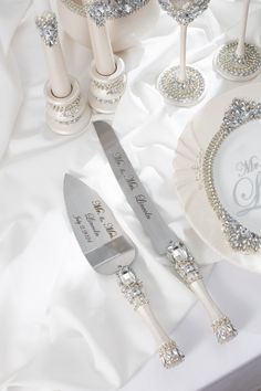 the table is set with silver and white decorations