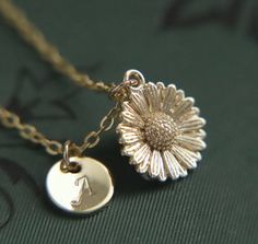 A beautifully intricate and dainty gold plated sunflower pendant hung from a gold plated fine chain. The flower measures 1.2cm (0.5") tall.  You can choose to add the personalisation of a gold plated hand stamped initial tag made with beautiful Calligraphic capital letters from the English language. If you decide that 'no initial required', a tag will not be added to the necklace.  Choose a necklace length tailored to you (please refer to the necklace length guide)  Your necklace will arrive to Gold Flower Jewelry For Anniversary, Elegant Daisy-shaped Gift Jewelry, Gold Flower-shaped Jewelry For Anniversary, Gold Flower Shaped Jewelry For Anniversary, Wedding Jewelry With Sunflower Design, Gold Engraved Necklace For Bridesmaid Gift, Adjustable Gold Necklace With Flower Pendant, Mother's Day Sunflower Design Jewelry, Engraved Gold Necklace For Bridesmaid Gift