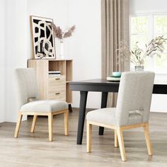 a dining room table with two chairs next to it