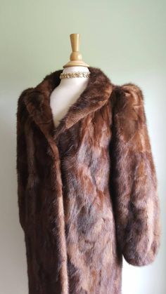 Old Hollywood glamour ✨📸 This vintage 1940s-style glossy mink coat features dramatic puffed sleeves, with padding at shoulders for structure and lift and elasticized wrists; a face-framing portrait collar; a deco-inspired geometric pattern to the fur; two pockets; and a sleek, longer length. Hidden front hook closures, fully lined. Monogrammed CHC. Era: 1960s Label: Strouss Pictured on a US size 6/8 dress form. ➸ visit on instagram | provenance_vintage Brown Winter Wedding Outerwear, Winter Wedding Brown Outerwear, Formal Brown Fur Coat For Fall, Classic Brown Fur Coat For Formal Occasions, Brown Winter Fur Coat For Formal Occasions, Brown Fur Coat For Formal Winter Occasions, Vintage Winter Fur Coat For Formal Occasions, Vintage Fur Coat For Winter Formal, Vintage Fur Coat For Winter Formal Occasions