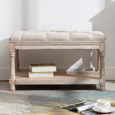 a wooden bench sitting on top of a rug next to a cup and saucer