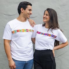 Original White Hand-Embroidered Unisex T-Shirts Made in Chiapas, Mexico. These hand-embroidered t-shirts are packed with vibrant, playful touches that will boost even the most basic t-shirt look. They contain vertical needlework done by Maya-Ch'ol artists in the amado Nervo region of Chiapas, Mexico, who blend their outstanding traditional geometric motifs utilizing a unique embroidery technique. The end product is a one-of-a-kind garment that distinguishes itself from the rest of your wardrobe.  Unisex. 100% fresh cotton. Horizontal hand-embroidery of traditional Ch'ol designs. Made in Chiapas, Mexico. Short sleeves. Crew neck. All embroideries are one of a kind, and the color will vary from t-shirt to shirt. If you'd like a specific set of colors, please contact us. We'd be honored Traditional Cotton Crew Neck Shirt, Traditional Crew Neck Cotton Shirt, White Casual Tops With Custom Embroidery, White Casual Top With Custom Embroidery, White Short Sleeve T-shirt With Floral Embroidery, White Floral Embroidered T-shirt, White Floral Embroidery Short Sleeve T-shirt, White Floral Embroidered Short Sleeve T-shirt, Summer T-shirt With Multicolor Embroidery And Short Sleeves