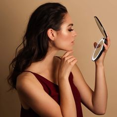 a woman holding a magnifying glass in front of her face