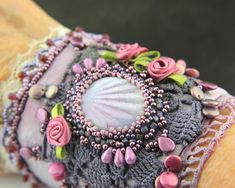 the bracelet is decorated with beads and flowers