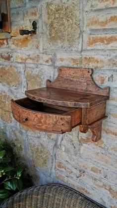 an old wooden shelf on the side of a brick wall