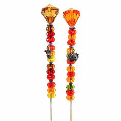 two colorful glass beaded candlesticks on white background