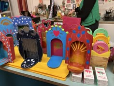 brightly colored paper crafts are displayed on a table