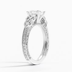 a white gold engagement ring with princess cut diamonds