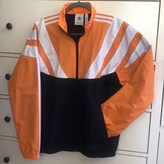 Nwt! Size Small. Bought In Uk And Never Worn. Navy Track Jacket For Spring Streetwear, Navy Outerwear For Streetwear In Spring, Navy Long Sleeve Windbreaker For Spring, Sporty Orange Windbreaker For Fall, Orange Sporty Windbreaker For Fall, Adidas Navy Casual Track Jacket, Casual Adidas Navy Track Jacket, Casual Navy Adidas Track Jacket, Spring Navy Windbreaker For Streetwear