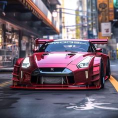 a red sports car driving down a city street