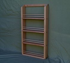 a wooden shelf sitting against a green wall