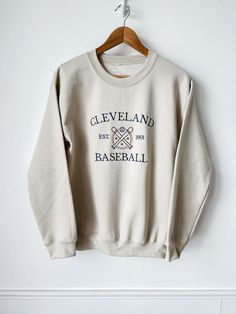 Cheer on your favorite team with this custom embroidered Baseball Crewneck! Wear this sweatshirt everywhere. Cheer on your MLB team from the bleachers or at home in a fleece sweatshirt! Order from sizes S-3XL. These are unisex sweatshirts, and they fit true to size! Look at your high school/ college/ sports tees and sweatshirts for sizing reference! This crewneck can be customized with 1-2 thread colors. Looking for a color sweatshirt or thread color not listed? Message me and I will see if I ca Cheap Varsity Sweatshirt With Embroidered Logo, High School Merch Ideas, Cute School Merch, White Team Spirit Sweatshirt With Embroidered Graphics, Game Day White Sweatshirt With Embroidered Graphics, White Game Day Sweatshirt With Embroidered Graphics, College Crew Neck Sweatshirt With Team Logo, White Sweatshirt With Embroidered Graphics For Team Spirit, Collegiate Sweatshirt With Letter Embroidery For Game Day