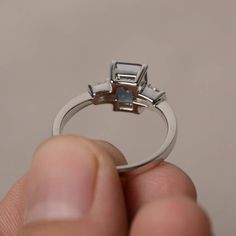 This is a gorgeous handmade creation. Its beauty is its simplicity & Elegance. The 6*8 mm emerald shape faceted lab alexandrite is crafted in solid sterling silver and with rhodium plated. All item is sent in a beautiful gift box If you have any idea of design your ring,pls contact me directly. You can realize more lovely stuff clicking the link https://www.etsy.com/shop/knightjewelry?refshopsection_shophome_leftnav Please leave the correct address and you phone number for delivering success Emerald Cut Sapphire Ring For Proposal, Silver Baguette Cut Ring For Proposal, Emerald Ring With Radiant Cut And Accent Stones, Modern Emerald Cut Emerald Ring With Accent Stones, Emerald Cut Topaz Anniversary Ring, Emerald-cut Topaz Ring With Halo Setting, Silver Emerald Ring With Radiant Cut And Accent Stones, Gia Certified Emerald Cut Sapphire Ring In Sterling Silver, Radiant Cut White Gold Topaz Ring