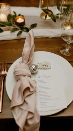 a place setting with silverware and napkins