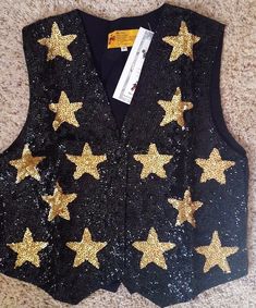 NEW WITH TAGS JC SEQUIN BLACK AND GOLD STAR  SEQUIN VEST MEDIUM ADDITIONAL SIZES ARE AVAILABLE PLEASE CONTACT US  A unique and Special vest Great for those fun holiday parties and costumes  Looks festive and dressy over that little black dress Western events, Equestrian events, Dance costumes School functions Completely set with sequins and beads. Satiny back, with Adjustable waist with buckle. Three snaps on the front. CONDITION: NEW Smoke-free environment/cat free  FLAT MEASUREMENTS APPROXIMAT Black Dress Western, Mardi Gra, Sequin Vest, Star Costume, Themed Outfits, Western Dresses, Character Outfits, Vest Top, Black Sequins