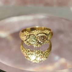 Add a touch of classic elegance to your collection with this stunning Vintage 10k Gold Ring featuring the iconic Black Hills Gold leaves design. Handcrafted with intricate detail, this size 11 ring showcases the beauty of bi-color gold, blending yellow and rose gold into a harmonious masterpiece. Features: Material: 10k Yellow Gold Design: Black Hills Gold with detailed rose and green gold leaves Size: 11 (Resizable by a professional jeweler) Condition: Excellent vintage condition with minimal signs of wear, reflecting its history and charm. Style: Timeless and versatile, perfect for everyday wear or special occasions. Why You'll Love It: This ring is more than just jewelry; it's a piece of history. The Black Hills Gold design is renowned for its unique artistry and heritage, making this r Black Hills Gold Rings Vintage, Vintage Gold Rings Engagement, Black Hills Gold Wedding Rings, Black Hills Gold Rings, Pretty Engagement Rings, Black Hills Gold Jewelry, Vintage Gold Rings, Earthy Jewelry, 10k Gold Ring