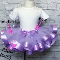 a tutule fabric bow is attached to a dress on a mannequin