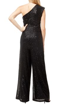 Sparkling sequins dazzle on this elegant one-shoulder jumpsuit crafted in a glamorous wide-leg silhouette. 49" length One-shoulder neck Sleeveless Sequin embellishment Wide-leg Stretch knit construction 95% nylon, 5% spandex Hand wash, line dry Imported Model stats: 5'10" height, 32" bust, 25" waist, 36" hip. Model is wearing size S. Elegant Strapless Jumpsuit With Sequins For Night Out, Elegant Strapless Sequin Jumpsuit For Night Out, Glamorous Strapless Jumpsuit For Party Season, Glamorous Strapless Jumpsuit For Formal Parties, Glamorous Strapless Jumpsuit For Prom, Glamorous Prom Jumpsuits And Rompers For Party Season, Glamorous Prom Jumpsuits And Rompers, Glamorous Jumpsuits And Rompers For Prom Party Season, Glamorous Formal Sequin Jumpsuits And Rompers