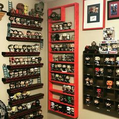 a room filled with lots of different types of action figures on shelves next to each other