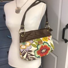 Fabulous Purse, Measurements Are In The Photos. Not A Shoulder Strap, Zipper Top New Without Tags. Canvas Type Material, Man-Made Leather Trim. Casual Brown Fabric Shoulder Bag, Everyday Brown Shoulder Bag With Floral Print, Casual Brown Fabric Bag, Brown Floral Print Crossbody Shoulder Bag, Spring Brown Shoulder Bag With Zipper Closure, Brown Shoulder Bag With Zipper Closure For Spring, Brown Floral Print Shoulder Bag For Daily Use, Brown Floral Print Shoulder Bag, Casual Brown Floral Print Bags