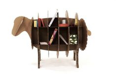 an animal shaped book shelf with books on it