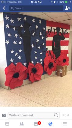 a wall decorated with poppies and an american flag