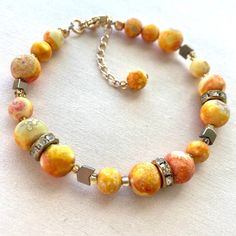 Sunrise beaded bracelet in 14kt gold filled hardware. Adjustable from 7 inches to 8.5 inches. Handmade using beads made of agate and gold plated hematite.  ⚠️No one bracelet is exactly like the other! there are many differences in bead color and pattern!⚠️ 💪Strong 49-Strand beadalon wire and crimps are used in this bracelet.  ✨Take good care of your jewelry. Store in box and clean off tarnish using cloth provided. Take your jewelry off to shower, workout, and put on cosmetics. Gold Beaded Agate Crystal Bracelet, Gold Bohemian Crystal Bracelet With 8mm Beads, Adjustable Orange Agate Bracelets, Adjustable Orange Agate Bracelet, Handmade 14k Gold Filled Beaded Bracelets, Gold Beaded Bracelet With Colorful 14k Gold Filled Beads, Handmade Orange Agate Beaded Bracelets, Gold Hand-strung Czech Glass Bracelets, Handmade Orange Agate Bracelets