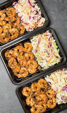 three trays filled with different types of food on top of a gray countertop