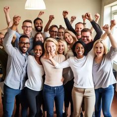 a group of people standing together with their arms in the air