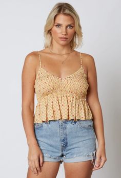 Update your basic style with the Gina Honey Floral Print Smocked V-Neck Ruffled Cropped Tank Top! A plunging V-neckline and shirred, cami strap bodice is made from rayon fabric (in a honey yellow and raspberry floral print), ending in a cute cropped and ruffled hem. Pair with your favorite ripped denim shorts for a cute warm weather look! Retro Inspired Outfits, Trendy Spring Fashion, Ruffled Crop Top, Floral Cami Top, Honey Yellow, Black Cami Top, Floral Cami, Ripped Denim Shorts, Black Camis