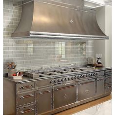 an industrial style kitchen with stainless steel appliances