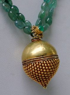 "An exclusive beautiful tribal pendant necklace from Rajasthan northern India. We sourced this piece of gem from a well known tribal family on the outskirts of Jodhpur. Solid well made 22 karat Gold sphere , the bottom half has tiny granulation ending with a tiny ball, the top half is quite shiny finish, set with a natural high grade Columbian emerald and strung with Emerald oval shape (cabochon) and gold beads. Ending with a beautiful gold s clasp. Total length-48 cm(18.72\")we can adjust lengt Temple Jewelry With Gemstone Beads For Rituals, Traditional Round Pendant Jewelry With Gemstone Beads, Traditional Gemstone Beaded Round Pendant, Traditional Jewelry With Large Beads In Round Pendant, Traditional Large Beads Round Pendant Jewelry, Traditional Necklace With Large Beads And Round Pendant, Traditional Beaded Necklace With Polished Round Pendant, Traditional Gold Necklace With Gemstone Beads, Traditional Beaded Necklace With Round Pendant