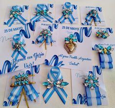 blue and white ribbon bows with brooches are arranged on top of each other