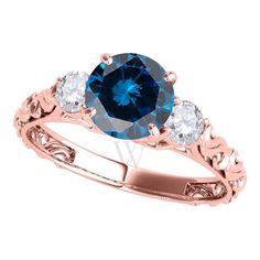 a rose gold ring with an oval blue diamond and three white diamonds on the band