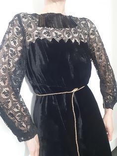 This is a gorgeous hand made Antique dress circa 1930s, possibly earlier because of the detailing. It is made in a jet black silk velvet that has a lovely fluid movement to it. The front neckline has an interesting detail of shiny black panelled sequins. The back neckline is an open scoop. There is black French chantilly lace detailing on the body and long sleeves, and a clever triangular velvet shaped edge that attaches the skirt and body of the dress to the lace upper body section. The skirt p Victorian Long Sleeve Party Dress, Vintage Velvet Party Dress, Vintage Black Velvet Dress For Party, Vintage Black Velvet Party Dress, Vintage Black Velvet Dress For Evening, Vintage 1930s Dress, Velvet Lace Dress, Vintage Velvet Dress, Fluid Movement