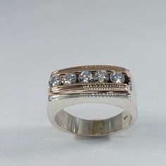 a white gold ring with five diamonds on the side, set in 18k white gold