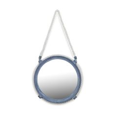 a round mirror hanging from a rope on a white wall with a blue ring around it