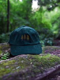 This Pine Trees Corduroy Hat is absolutely perfect for pairing with a flannel, sweatshirt, or pretty much anything really! It's the perfect hat to wear while going camping, hiking, or even a great gift to give to your natural-loving friend or significant other. 10% of the profits from the purchase of this hat will go to the National Park of your choice. * 100% cotton corduroy * Soft, unstructured crown * Cotton twill sweatband and taping * Adjustable buckle This product is made especially for you as soon as you place an order, which is why it takes us a bit longer to deliver it to you. Making products on demand instead of in bulk helps reduce overproduction, so thank you for making thoughtful purchasing decisions! Corduroy Hats, Embroidered Corduroy, Granola Girl Aesthetic, Hiking Hat, Corduroy Hat, Flannel Sweatshirt, Crunchy Granola, Going Camping, Pine Design