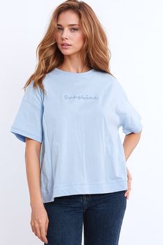 Elevate your casual wardrobe with this charming and super comfortable oversized t-shirt featuring textured fluffy text at the front spelling the word "sunshine." Perfect for adding a touch of whimsy to your everyday look.    Design:  Oversized t-shirt with a classic crew neckline and short sleeves for a relaxed and laid-back vibe.   Textured Text:  Delightful fluffy text at the front spells out the word "sunshine," adding a playful and cheerful element to the design.   Fabric:  Crafted from 100% cotton for a soft and breathable feel, ensuring comfort all day long.   Fit:  Relaxed fit and oversized silhouette offer a comfortable and effortless look.   Styling:  Pair with denim shorts and a cardigan for the perfect spring ensemble, ideal for casual outings or relaxed weekends.   Sizing:  Ava Blue Relaxed Fit Top With Embroidered Text, Blue Tops With Embroidered Text And Relaxed Fit, Blue Tops With Embroidered Text For Spring, Oversized Short Sleeve Top With Embroidered Text, Everyday Spring Top With Embroidered Text, Spring Everyday Top With Embroidered Text, Oversized Tops With Embroidered Text For Everyday, Oversized Top With Embroidered Text For Everyday, Oversized Top With Embroidered Text For Spring