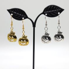 Handmade earrings featuring either a gold or silver pumpkin charm! Celebrate Halloween the spooky way with these cute dangle earrings.  Featuring either a silver-color or gold-color charm, these earrings will go with most costumes. Halloween Gold Dangle Jewelry, Gold Dangle Halloween Jewelry, Halloween Novelty Metal Jewelry, Novelty Metal Halloween Jewelry, Gold Dangle Jewelry For Halloween, Spooky Silver Nickel-free Earrings, Spooky Nickel-free Silver Earrings, Gold Novelty Earrings For Halloween, Nickel-free Novelty Gold Earrings