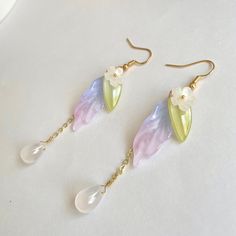 * Elegant dangle floral flower daisy earring. Unique design high quality *Material: glass/14k gold plated hook *Color: white/green/purple 🤍Hypoallergenic 🤍 Handmade with love 🤍Click👇🏻 Find more Jewelry https://www.etsy.com/shop/WandWZONE 🤍 SHIPPING 🤍  * USPS First Class Shipping Service with tracking number * All products will be shipped from USA 🤍  CARE INSTRUCTIONS 🤍  * Avoid chemicals such as shampoo conditioner perfumes or sprays * Avoid getting your jewelry wet * Store jewelry in a Spring Flower Dangle Earrings, Spring Flower Drop Earrings, Spring Teardrop Flower Earrings For Pierced Ears, Spring Gift Teardrop Dangle Earrings, Whimsical Drop Earrings With Flower Charm, Spring Dangle Flower Earrings, Earring Unique, Shrink Plastic Jewelry, Flower Daisy