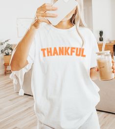 Embrace the spirit of gratitude this season with our Comfort Colors® Cute Thankful Shirt, featuring a cozy fit perfect for Thanksgiving gatherings and crisp autumn days. Made with soft, durable fabric adorned with a charming pumpkin design, this shirt captures the essence of fall and invites you to celebrate with family; grab yours today and wear your thankfulness with pride! Processing Time: 3-7 Business Days Delivery Time: 3-5 Business Days Processing and Delivery times are estimated and may t Grateful Shirt, Thankful Shirt, Crisp Autumn, Thanksgiving Family, Autumn Days, Thanksgiving Shirt, Family Shirt, Pumpkin Shirt, Fall Shirt