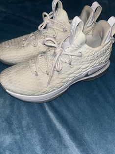 These are a steal! Selling on GOAT and StockX for well over $300-$400. Elevate your sneaker game with the Nike LeBron 15 Low in White Metallic Silver. This stylish and versatile sneaker features a low top shoe shaft style, making it perfect for both casual and athletic wear. The shoe boasts a sleek white and metallic silver colorway, with the iconic Nike LeBron logo adorning the side. Crafted with comfort and performance in mind, the Nike LeBron 15 Low is equipped with a breathable and durable design, making it ideal for any occasion. This sneaker is available in a men's US shoe size 10.5, and is part of the Nike LeBron product line. The shoe was released on April 2, 2018, and has a unique style code of AO1755-100. Elevate your style and game with the Nike LeBron 15 Low. Lightly worn and o Lebron Logo, Lebron 15 Shoes, Athletic Shoes Nike, Sneaker Games, Nike Lebron, Athletic Wear, Top Shoes, Low Top, Nike Shoes