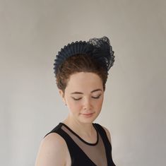 From our UNIQUE COLLECTION this very flattering halo crown style is very much in vogue this season. This one has been hand blocked and wired using traditional millinery techniques. Formed from navy sinamay straw and overlaid with pleated crin.  A sculptural shell adorns one side. ONE OF A KIND - READY TO SHIP  UK - STANDARD DELIVERY  1-2 DAYS           EXPRESS NEXT DAY  INTERNATIONAL  -STANDARD DELIVERY  5-10 DAYS                                    EXPRESS 3-4 DAYS CHOOSE DELIVERY METHOD AT CHEC Adjustable Tall Crown Headband, Fitted Evening Headband, Structured Crown Headpiece For Royal Ascot, Adjustable Crown Headpiece For Evening, Elegant Black Headpiece With Tall Crown, Adjustable Round Crown Headpiece For Evening, Adjustable Structured Crown Hair Accessories For Evening, Elegant Fitted Crown Headpiece, Adjustable Hair Accessories With Matching Headband