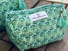 This green floral handmade cosmetic bag and toiletry bag set comes in 3 different sizes! A beautiful way to store your skincare, personal care or make-up for everyday use and travel! This luxurious set of three toiletry bags and travel handmade cosmetic bag set features a waterproof plastic lining with four interior pockets, a zipper top adorned with a beaded tassel, and a 100% quilted cotton exterior that is hand block printed in Jaipur, India. Set of 3 Toiletry and Handmade Cosmetic Bags Set M Green Rectangular Cosmetic Bag For Daily Use, Rectangular Green Cosmetic Bag For Daily Use, Rectangular Green Cosmetic Bag, Green Pouch Cosmetic Bag For Daily Use, Green Cosmetic Pouch For Daily Use, Handmade Green Travel Pouch, Handmade Green Pouch For Travel, Gift Cosmetic Bag With Removable Pouch In Green, Handmade Green Pouch