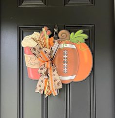 a door hanger with a football and pumpkin design on it's front door