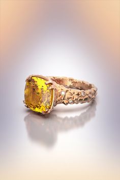 Citrine and diamonds ring in 18k or 14k genuine gold made in Italy. Raw and polished gold statement ring ,Italian fine jewelry ring. A stunning ring with a 12mm x 12mm Citrine and six G VS diamonds, a stunning rock texture worked with rough and shiny surfaces. Available on request with other gems. Designed and crafted in Italy. ❥Details Gemstones Citrine Shape: fancy cut Measurements: approx. 12mm x 12mm x 6,6mm, 5,3 ct Quality: natural Diamonds: 0,045 ct natural diamonds Band measurements: appr Formal Yellow Sapphire Ring With Rose Cut Diamonds, Fine Jewelry Yellow Sapphire Rings With Diamond Accents, Luxury Yellow Sapphire Promise Ring, Yellow Sapphire Diamond Ring With Prong Setting, Formal Yellow Sapphire Ring With Prong Setting, Unique Yellow Gold Diamond Ring With Center Stone, Formal Yellow Sapphire Ring With Diamond Cut, Rock Texture, Italian Gold Jewelry