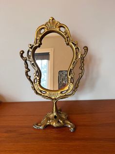 a mirror sitting on top of a wooden table