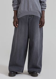 Color: Dark Grey Midweight woven cotton denim Oversized fit Exaggerated wide leg Half elasticated waistband Slant hip pockets Back patch pockets Front button closure Zip fly Unlined 100% Cotton Machine Wash Cold By The Frankie Shop. Imported Casual Washed Black Wide-leg Jeans, Oversized Wide Leg Washed Bottoms, Wide Leg Washed Black Pants With Five Pockets, Washed Wide Leg Bottoms For Streetwear, Wide-leg Streetwear Jeans With Belt Loops, Oversized Wide Leg Bottoms, Wide-leg Jeans For Streetwear With Belt Loops, Gray Wide-leg Cotton Jeans, Wide Leg Washed Bottoms For Streetwear